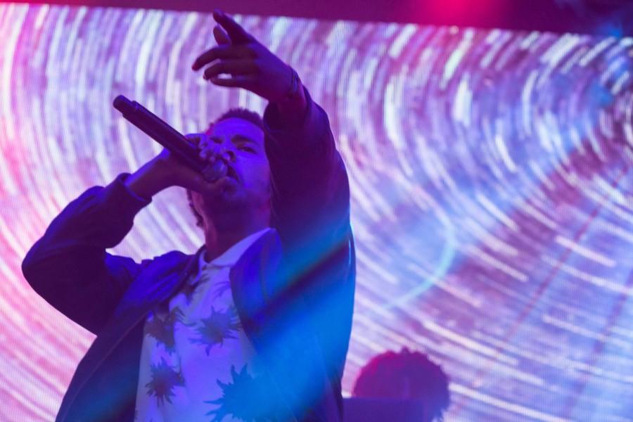 Earl Sweatshirt points at the crowd at neon Desert. 