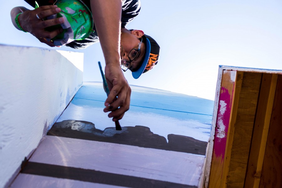 Artist Hore Herrera paints the Neon Desert board.