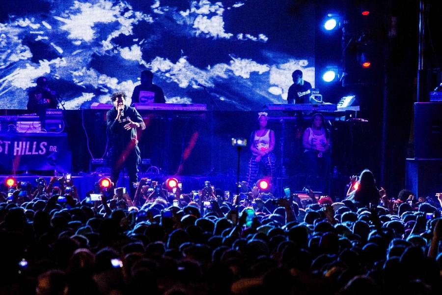 Hip hop artist J Cole performs onstage.