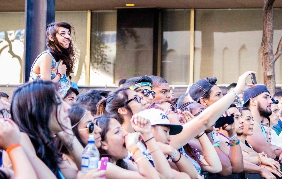 Concert goers watch a band perform at Neon Desert Music Festival. 