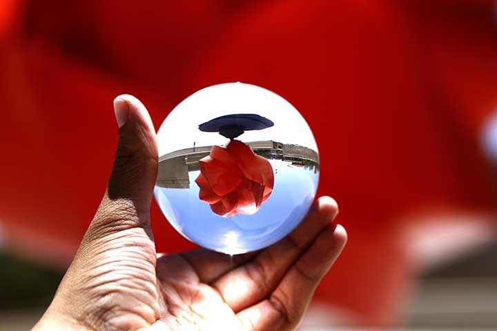 Sculpture by Mexican artist Sebastian, Esfera Cuántica Tlahtolli as seen through glass sphere.