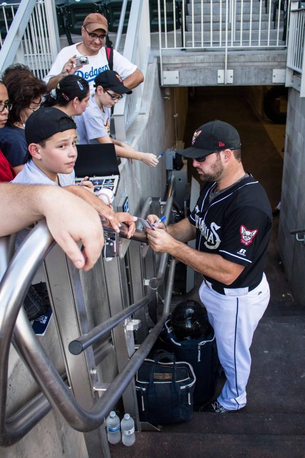 Cody Decker signs autographs for young fans. 