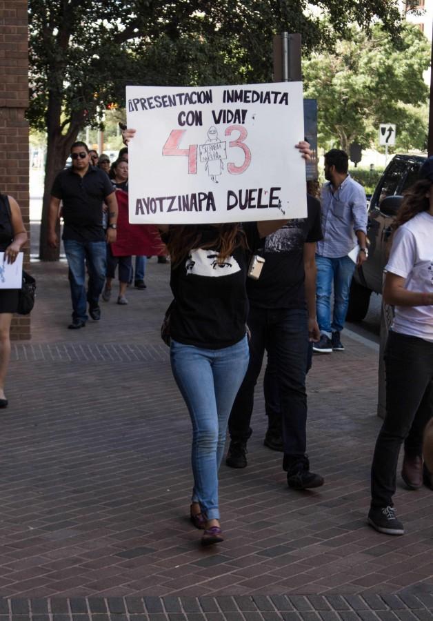 A UTEP student holds up a sign throughout the activist march. 