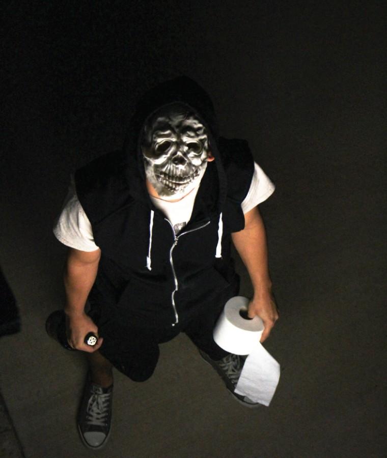 A male student poses as someone that may participate in halloween vandalism. 