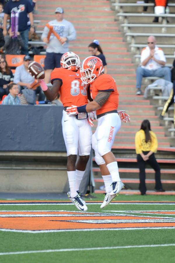 Senior Tyler Batson celebrates the first touchdown of the game with a fellow teammate. 