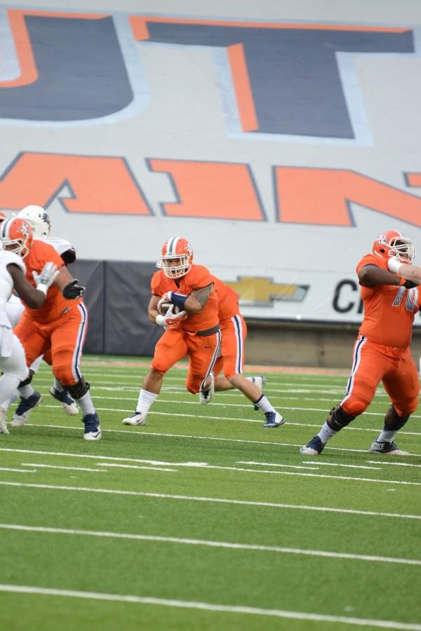 A UTEP running back evades defenders. 