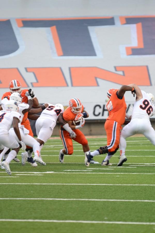 A UTEP running back evades defenders.