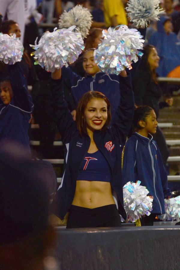 A Miner dancer watches the game.  