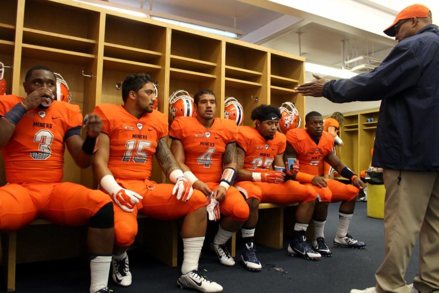 Before the game begins, UTEP players have a discussion with their coach. 