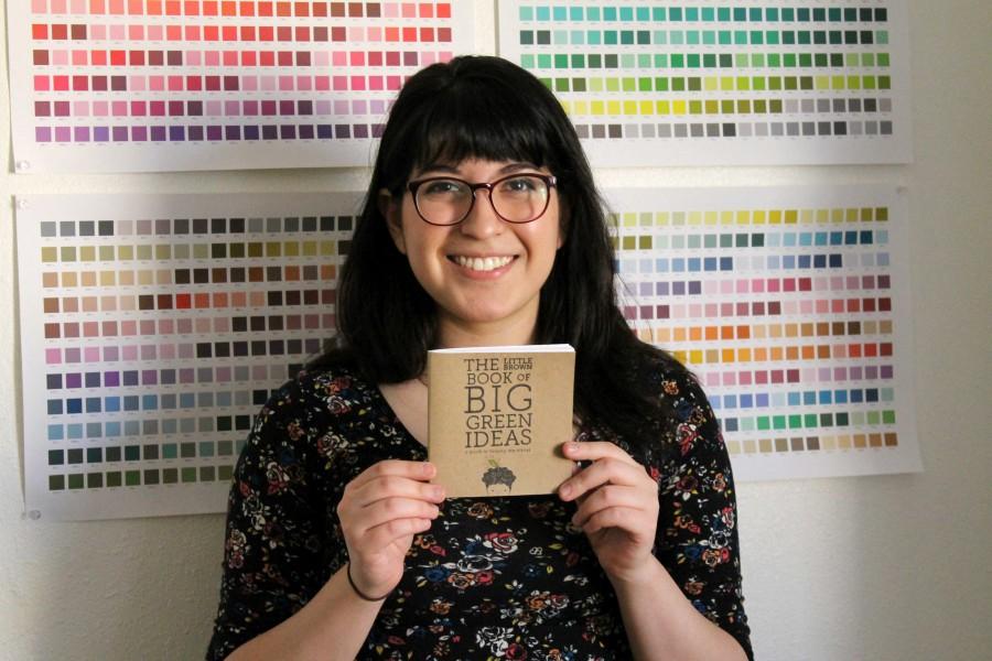Senior art major Leah Tellez shows off a book she designed herself. 