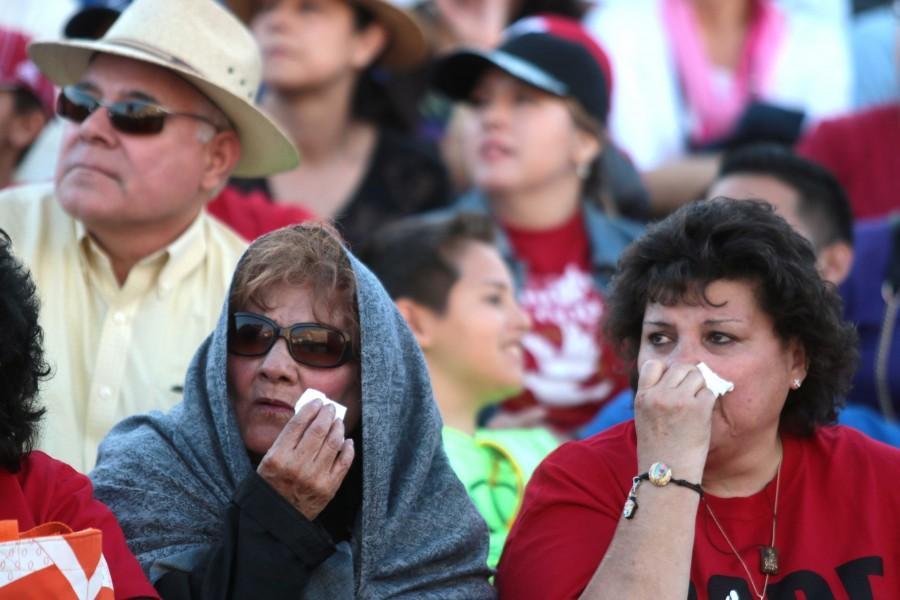 Two women show emotion at The Sun Bowl Stadium to watch Pope Francis deliver mass in Ciudad Juarez, Mexico. 