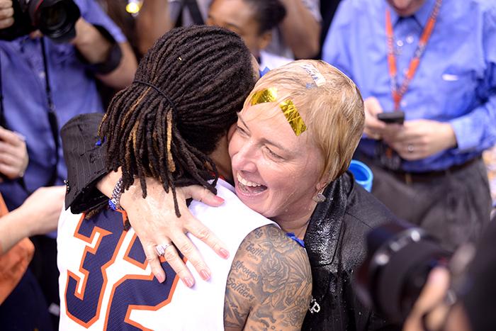 Head coach Keitha Adams hugs graduating guard Chrishuana Parker after getting a gatorade shower from her team.