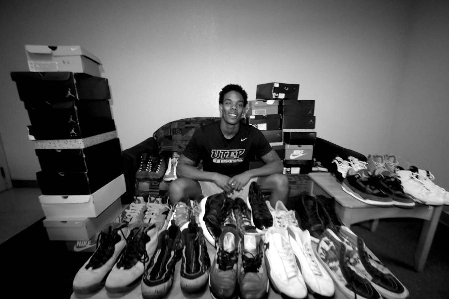 Shooting guard Omega Harris shows off his extensive shoe collection, which is housed in his dorm room.