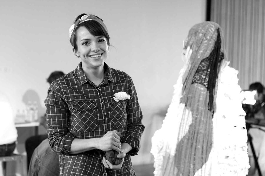 Senior studio art major Heather Mawson molds clay as part of her piece “Old, New, Borrowed, Blue” at the Glass Gallery. 