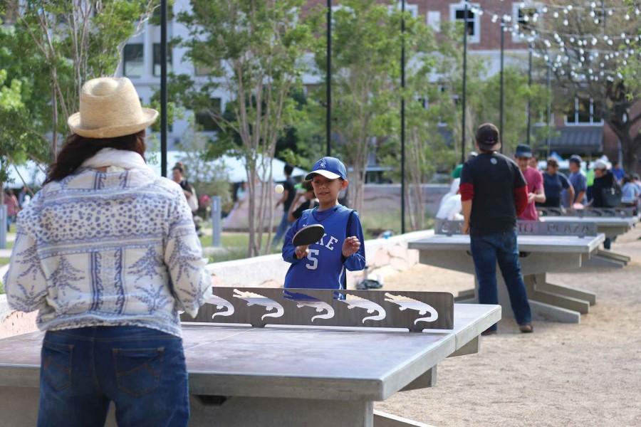 Visitors enjoy playing a game of pong at the San Jacinto Plaza. 