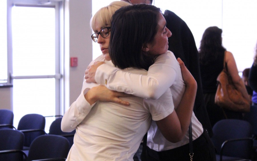 Melissa Stearns, close friend and P.A.S.S Session leader for Professor Foust, and former student console each other at Richard Foust's memorial service held at UTEP.