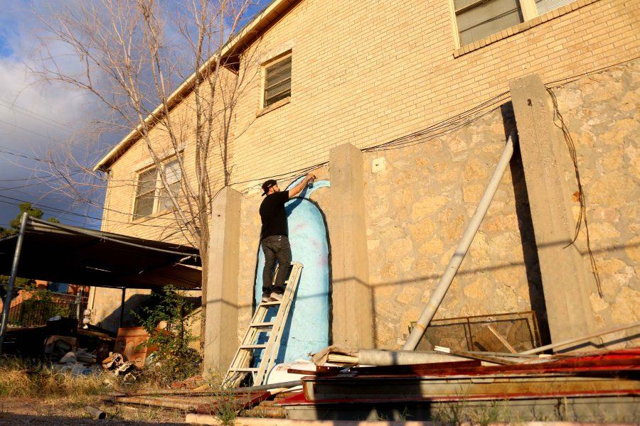 Local El Paso artist Matthew Martinez paints a mural near campus.