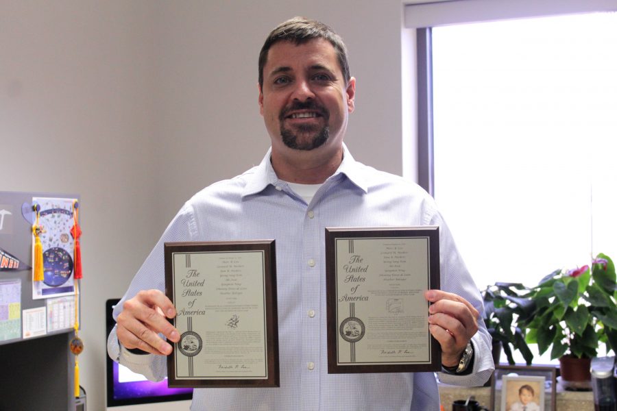 Marc Cox, Ph.D., associate professor at UTEP’s Department of Biological Sciences, holds his 2016 Texas Inventor of the Year awards. 