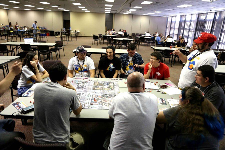 Boarder City Game Convention attendees play a zombie board game the second day of the convention. 