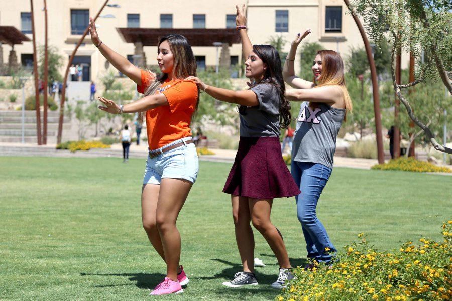 (From left to right) Junior psychology major Clarisse Sanchez, junior kinesiology major Victoria Rodriguez, and sophomore electrical engineering major Astrid Chacon dance in Centennial Plaza as part of Welcome Back week. 