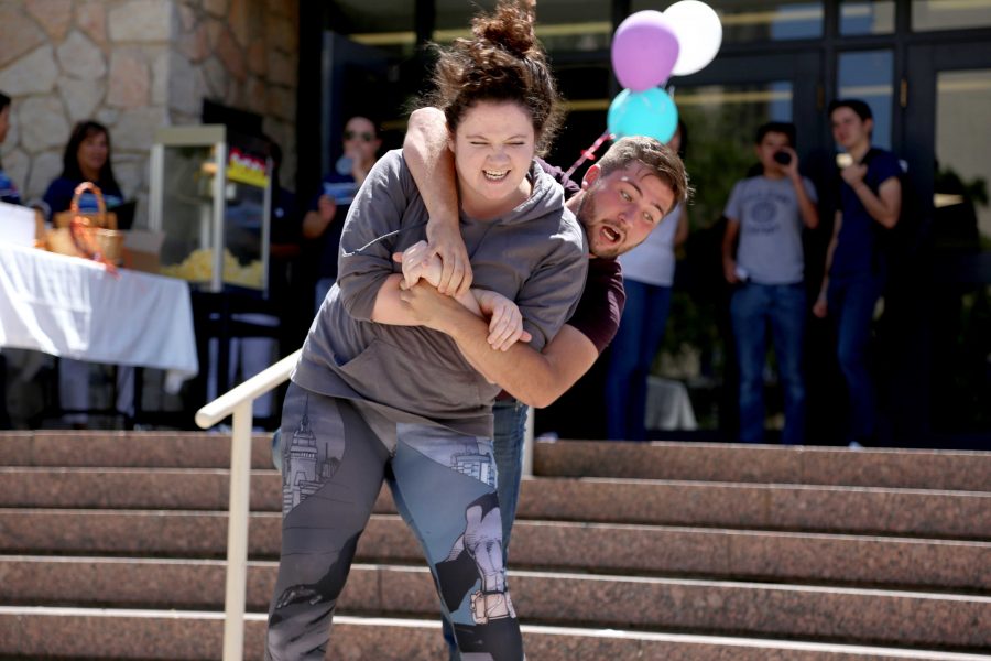 Sophomore theater major Jared Berry hops on the back of senior theater major Katherine Daniel as part of a sneak peak to upcoming play, The House on Mango Street, at the UTEP Dinner Theater.