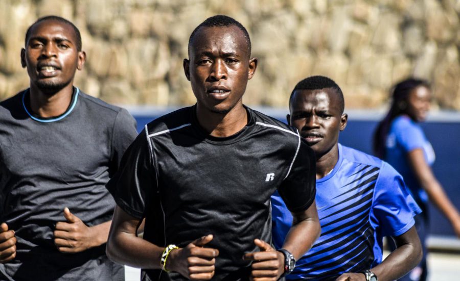 Senior Evans Kiprono leads a pack of runners during a 2015 practice at Kidd Field.