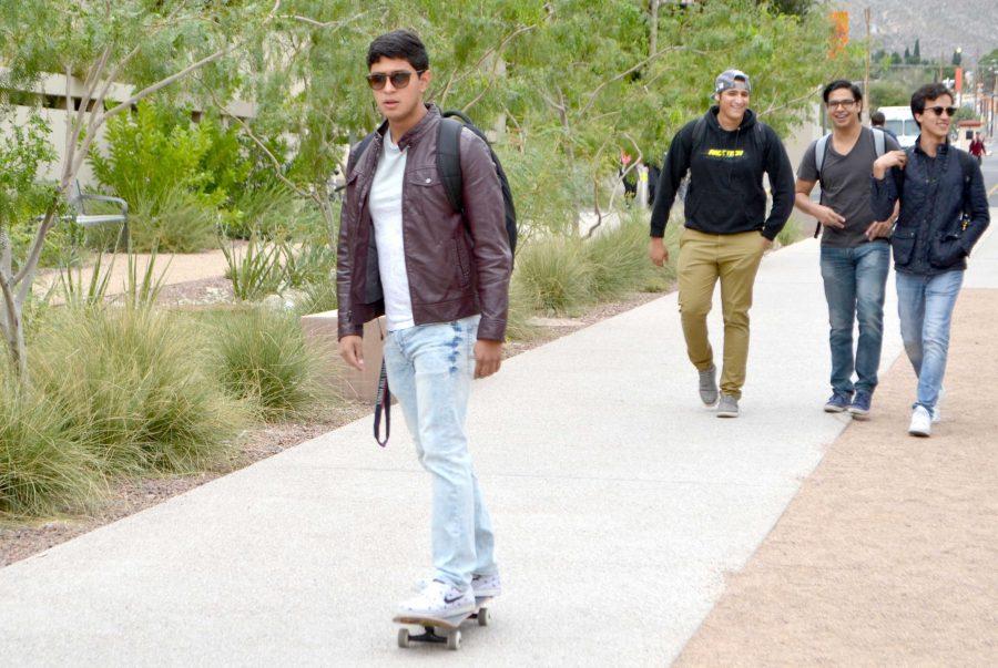 Skateboarders, longboarders and penny boarders often cruise between pedestrians on campus to get to class.