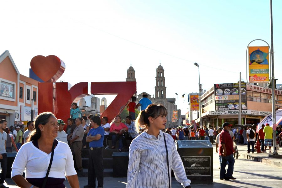 Two women stand in the middle of downtown Juárez, near the Our Lady of Guadalupe Cathedral. 