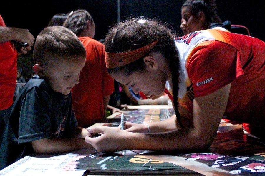 Players stayed after the game to sign posters for proud fans