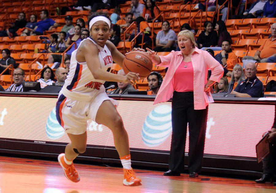 Lulu McKinney dashes the court, while Coach Keitha Adams instructs in the background