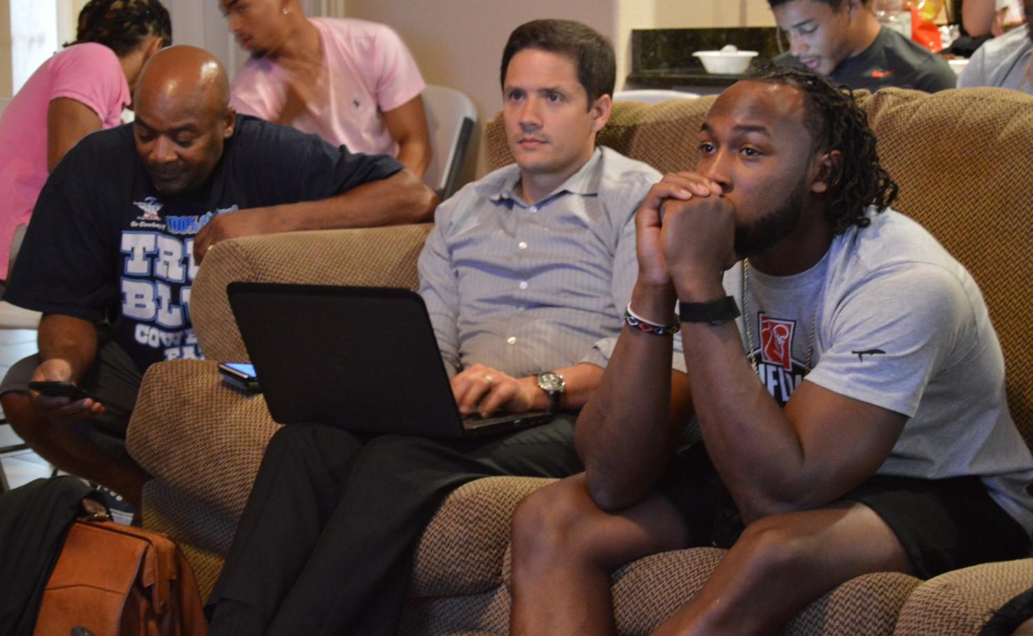 Aaron+Jones+and+agent+Chris+Cabott+watch+the+NFL+Draft.