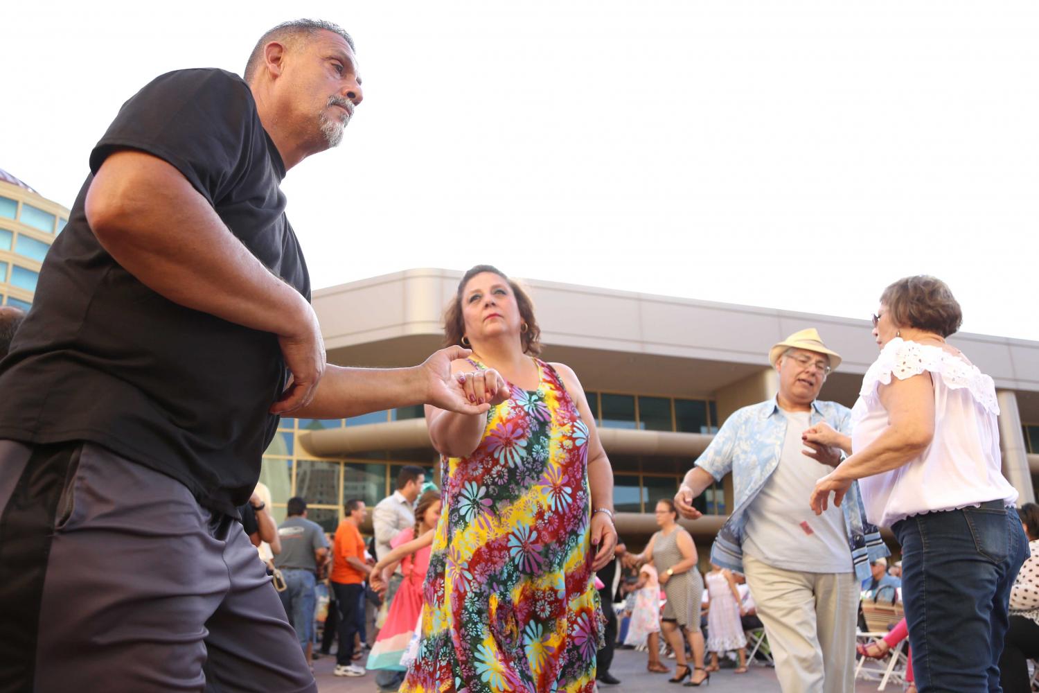 Two couples dance to the music at the Civic Center Plaza on Friday, June 2. 