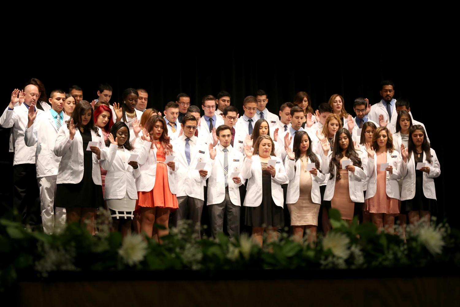 Students recite the oath of a pharmacist to end the ceremony.