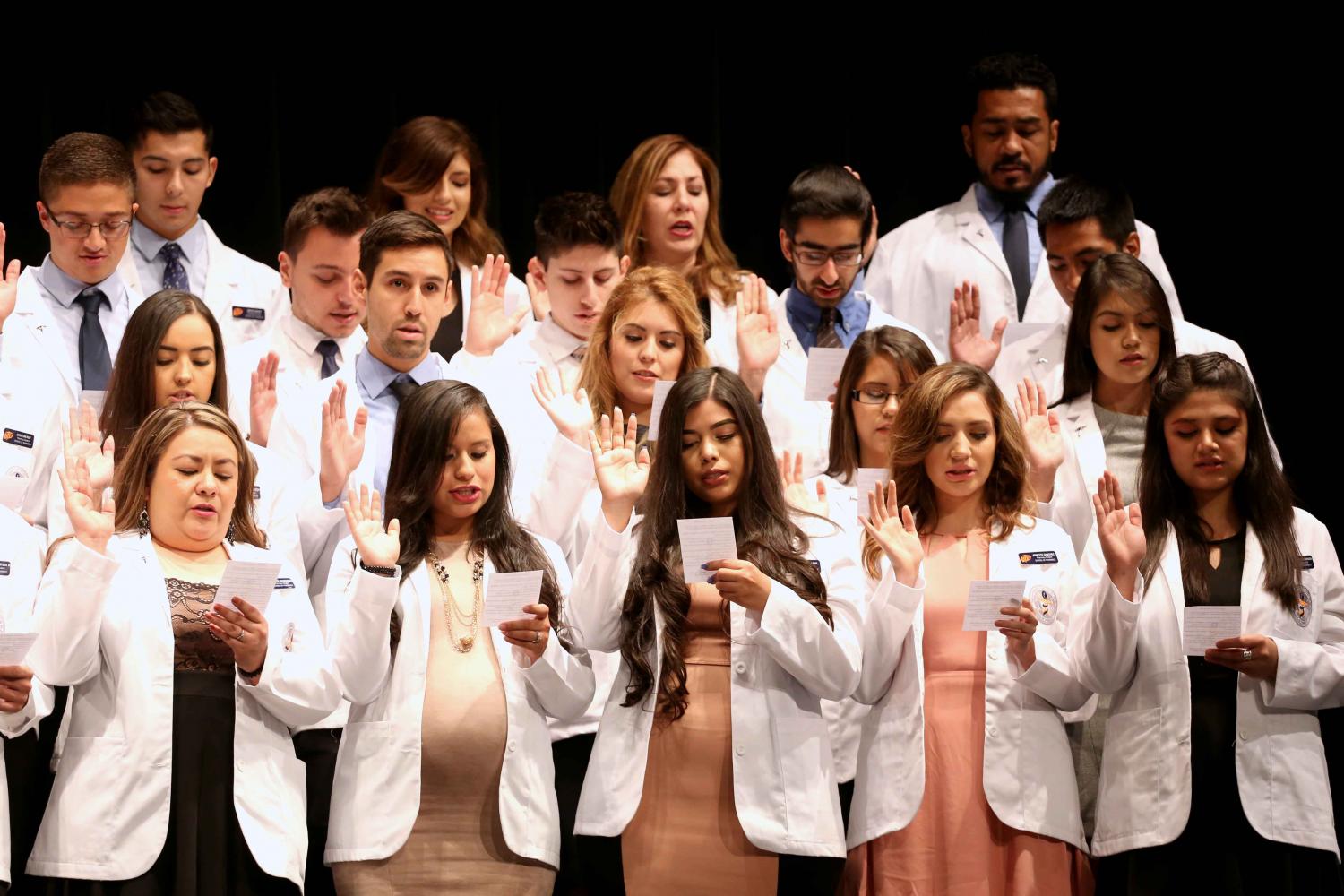 Students recite the oath of a pharmacist to end the ceremony.