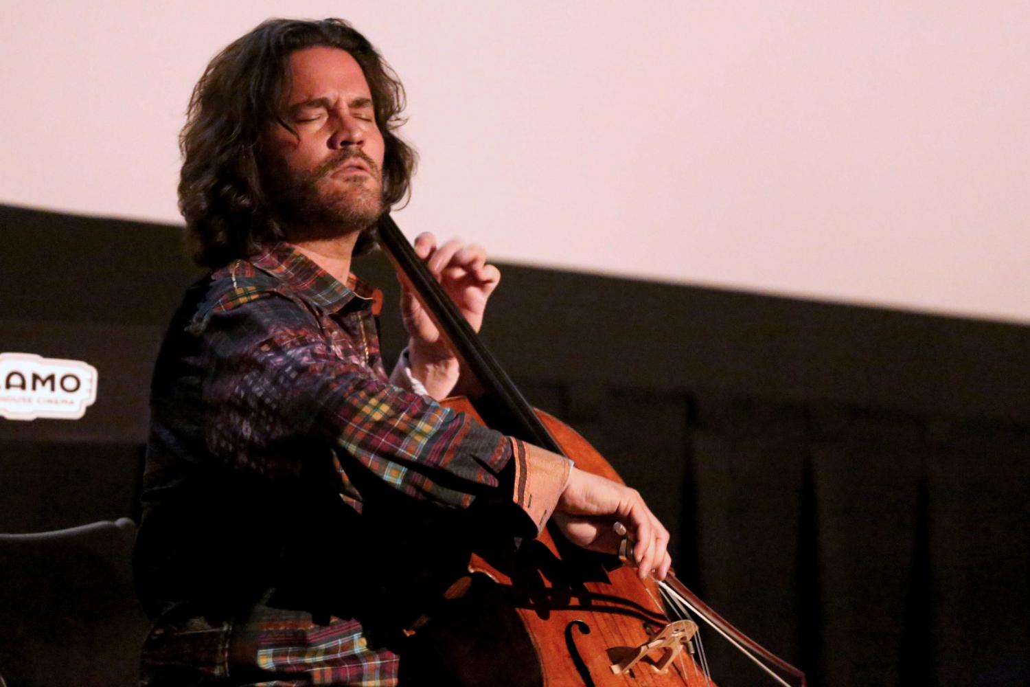 Zuili Bailey plays his 325 year old cello before the showing of Goldfinger at the Alamo Drafthouse.