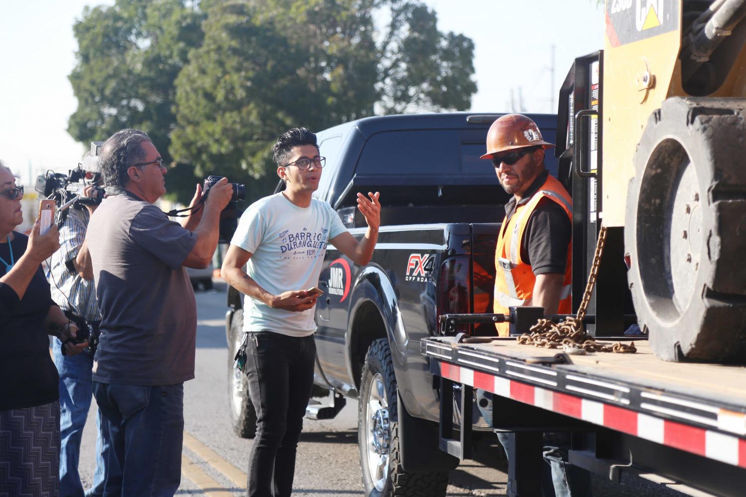 The community face the demolition crews after they destroyed significant areas out of five buildings in the neighborhood Tuesday morning.