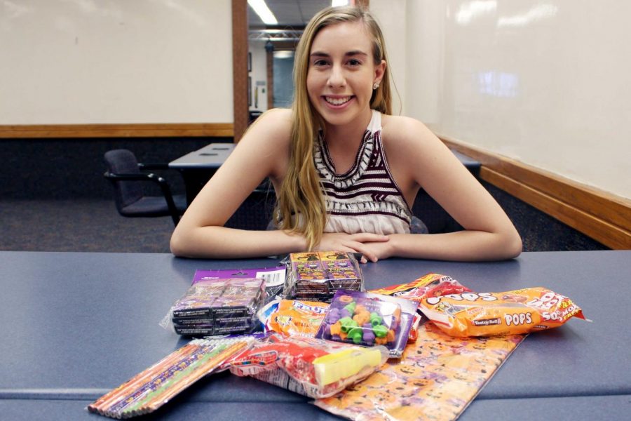 Junior biological sciences major Karina Monticone delivers Halloween candy and presents to underprivileged individuals.