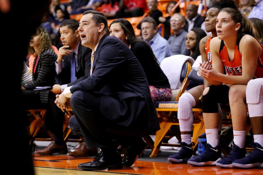 New women's basketball coach Kevin Baker watches the game from the sideline.