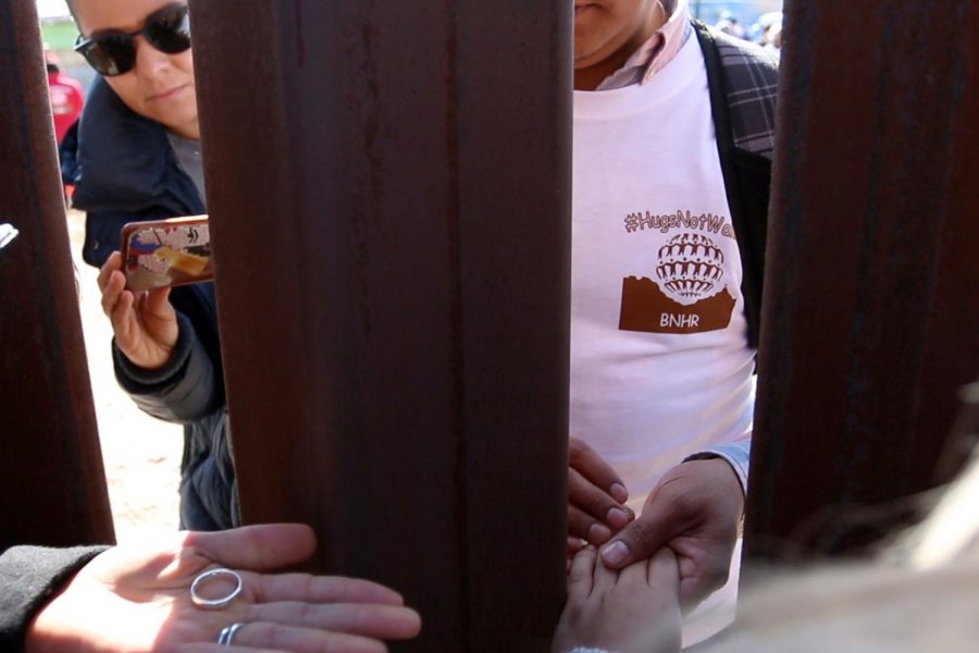 Rogelio Dominguez Parra holds Miriams Orozco Gonzalez hand minutes before getting married across the fence that divides Mexico and the U.S. on Sunday, Dec. 10, 2017.