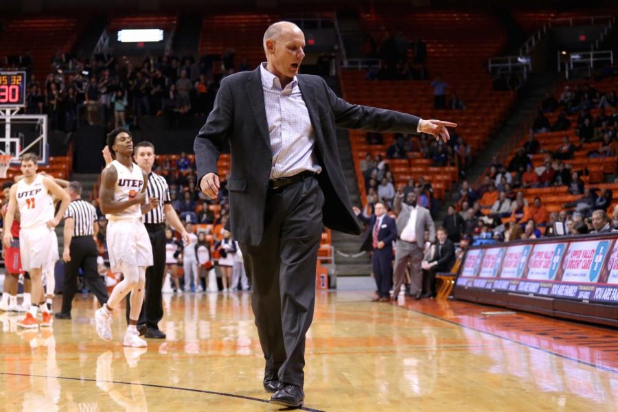 Interim head coach Phil Johnson exits the court as he is thrown out of the game.