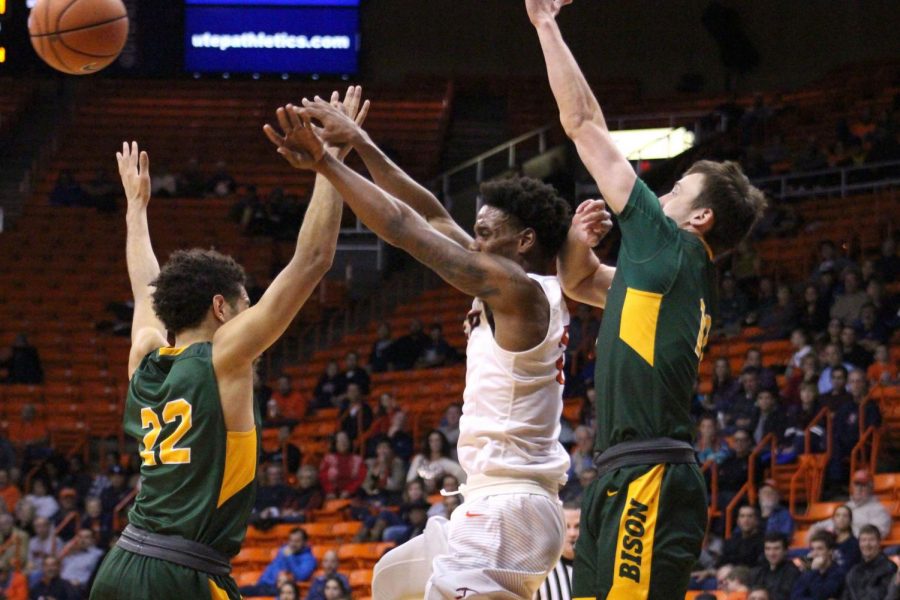 Omega Harris attempts to pass the ball through the double team of the Bison. 