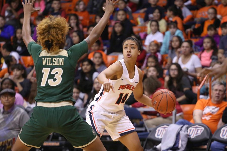 Junior guard Najala Howell looks to make a pass around Charlottes defense.  