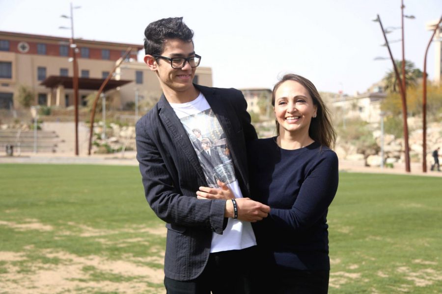 Maria Fuentes, a public health graduate student, hugs her son Darío Barrera who has autism. Fuentes was inspired to create the event UTEP Lights Up Blue for Autism Awareness on April 2. 