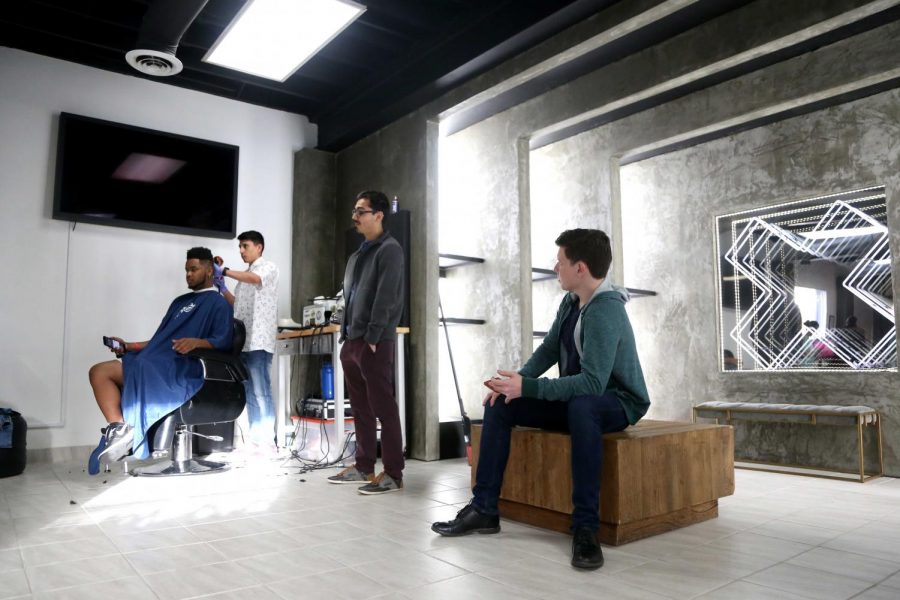 Attendees line up to get a hair cut at the Outpost Pop Up Pit Stop on Thursday, March 15.  