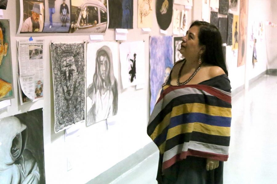 Betsabee Romero looks at the art work of students at the Rubin Center for the upcoming annual Juried Student Art Exhibition. 