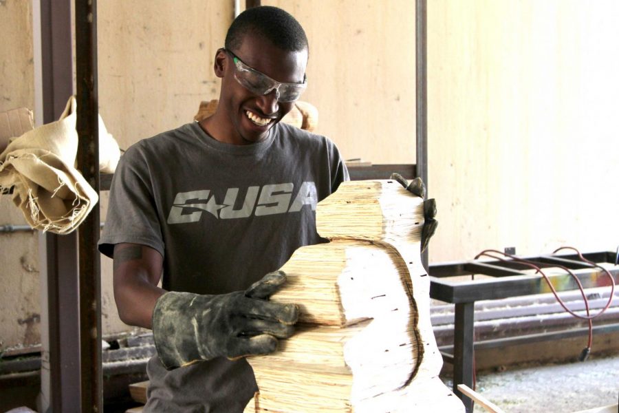 Horn works on his abstract wood sculpture in a studio at Fox Fine Arts.