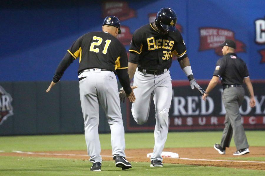 Right fielder Jabari Blash high fives manager Keith Johnson on his way to home base after hitting a home-run on the Chihuahuas opening night on Tuesday April 10 at Southwest University Park.