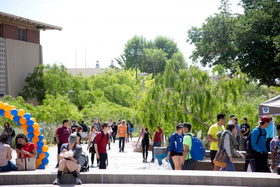 Students walk to and from class by the first Miner Fest  on Wednesday, April 18 at Centennial Plaza. 