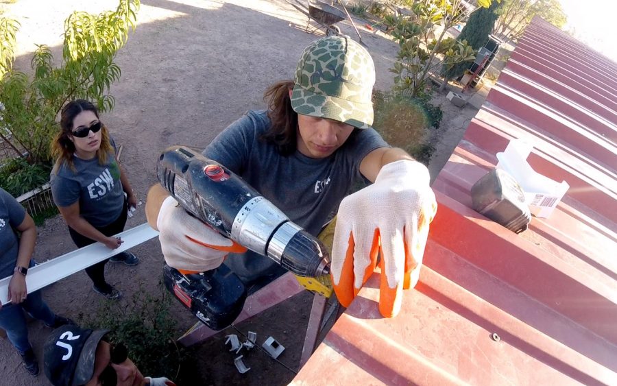 Francisco Bunsow, a sophomore in Construction Engineering and Management at UTEP helps drill in a gutter alongside other Engineering for a Sustainable World members. The group worked on a rainwater harvesting system for  Las Pampas residents, a colonia outside of Presidio, Texas.  