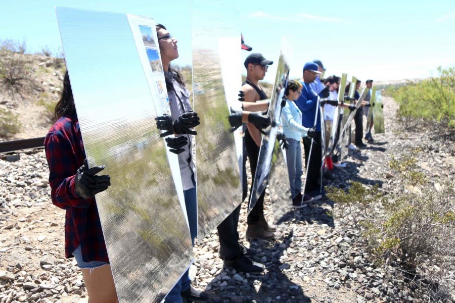 (Left) Volunteers from the El Paso and Las Cruces region hold Mylar mirror panels at Ardovino’s Desert Crossing on Saturday, April 31. (Right) Artist Steven Randall instructs the volunteers on where to stand to create the mirage. 